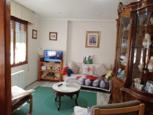 a living room with a couch and a table at CASA EL CASTAÑÉU in Arriondas +4 photos