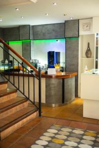 a lobby of a hotel with a counter and stairs at SUNDOS Feria Valencia in Valencia