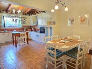 a kitchen and dining room with a table and chairs at Birdsing Cottage in Dassia