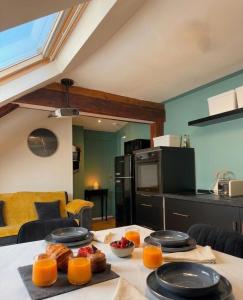 a kitchen with a table with plates of food on it at le petit château in Chambéry