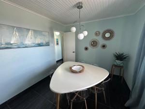 a white table with a bowl on it in a room at Pico Island Villas 117 - Natural Pools and Incredible Views in São Roque do Pico