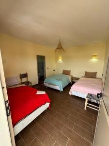 a bedroom with two beds in a room at ,,,''' Sidi kaouki Tayoukhte Surf House with Pool ''' ,,, Surfing lessons, Horse Riding & Quad adventures ,,, Local experiences all in one place in Sidi Kaouki
