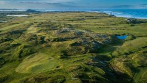 an aerial view of a golf course on a mountain at Village Centre Haven in Clifden