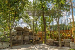 a garden with trees and a rock wall at Casa Vlasia in Snagov