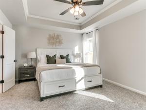 a bedroom with a white bed and a ceiling fan at New Dream Home in Broken Arrow! in Broken Arrow