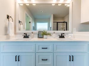 a bathroom with two sinks and a large mirror at New Dream Home in Broken Arrow! in Broken Arrow