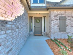 a house with a brick wall and a door at New Dream Home in Broken Arrow! in Broken Arrow
