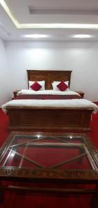 a bedroom with a large bed with a red floor at Villaggio Hotel in Khaplu