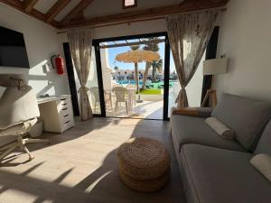a living room with a couch and a table with an umbrella at Casas Lapa in Costa Teguise