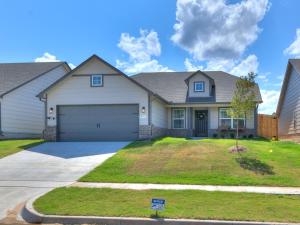 a house with a driveway and a garage at Spacious Retreat with Vaulted Ceilings & Primary Suite! in Broken Arrow