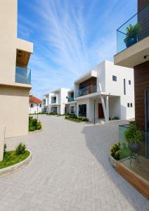 an empty courtyard of a building with white buildings at Executive Cozy Suite at THE HIDDEN DOMUS I Wenchi Suite in Accra