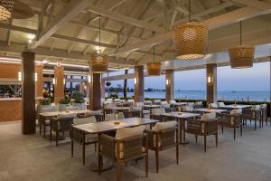 a restaurant with tables and chairs and a view of the ocean at Side Star Beach Hotel - Ultra All Inclusive in Side