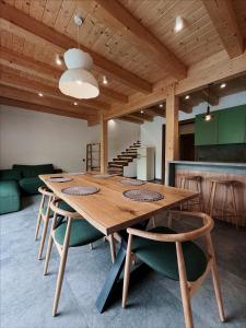 a large wooden table and chairs in a room at Альпійські шале Душа in Palyanytsya