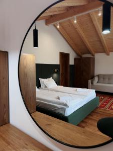 a bedroom with a bed in a round mirror at Альпійські шале Душа in Palyanytsya +31 photos
