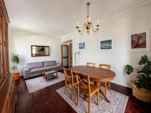 a living room with a table and a couch at SolMar View Apartment, Azores in Ponta Delgada