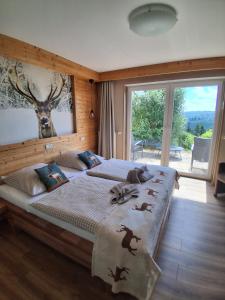 a bedroom with a large bed with birds on it at Landhotel Fernsicht in Winterberg