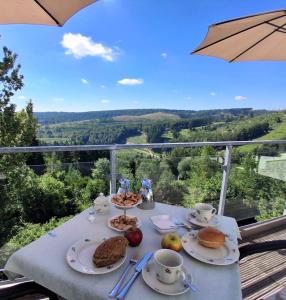 a table with plates of food on it with a view at Landhotel Fernsicht in Winterberg