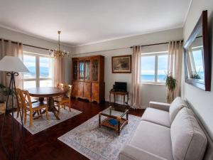 a living room with a couch and a table at SolMar View Apartment, Azores in Ponta Delgada