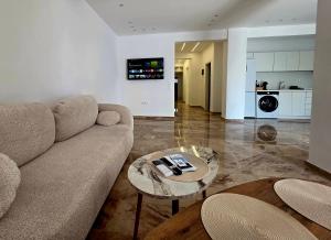 a living room with a couch and a table at Eantos Studios and Suites in Perea