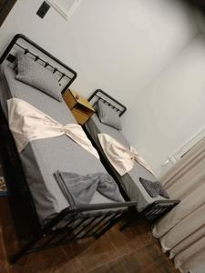 a bed with a yellow pair of scissors on it at Britannia Apartments in Gjirokastër