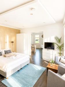 a bedroom with a large bed and a living room at Villa Georgi in Leipzig