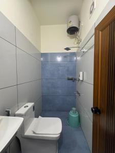 a small bathroom with a toilet and a shower at Regal residency in Perintalmanna +28 photos