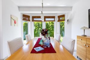 a dining room with a wooden table and white chairs at Carpe Diem in Wieck