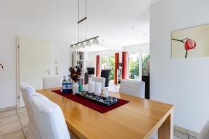 a dining room with a wooden table and white chairs at Carpe Diem in Wieck