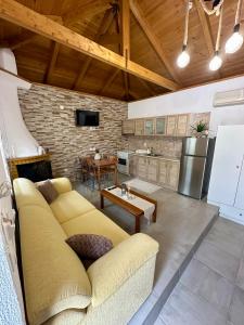a living room with a couch and a kitchen at Elaion Thea2-Nies in Soúrpi