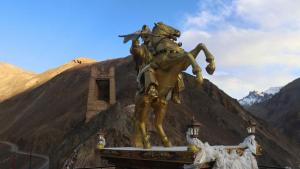 a statue of a man on a horse in front of a mountain at Wanla Eco Residence in Tarklak