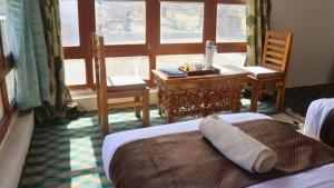 a bedroom with a desk and a bed and a window at Wanla Eco Residence in Tarklak +3 photos