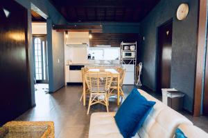 a living room with a white couch and a table at MOTOBU Ocean Private Villa in Motobu