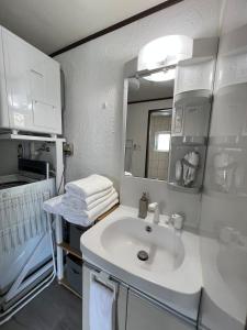 a bathroom with a sink and a mirror at MOTOBU Ocean Private Villa in Motobu +20 photos