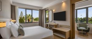 a hotel room with a bed and a television at Side Star Beach Hotel - Ultra All Inclusive in Side