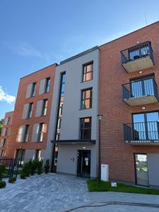 an apartment building with a brick at Apartament Cysterski Pelplin in Pelplin