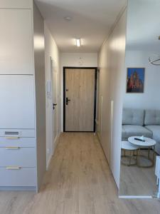 a living room with a couch and a table at Apartament Cysterski Pelplin in Pelplin