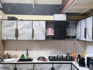 a kitchen with black and white marble counter tops at Mount Homestay in Nedukandam