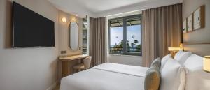 a hotel room with a bed and a window at Side Star Beach Hotel - Ultra All Inclusive in Side +50 photos