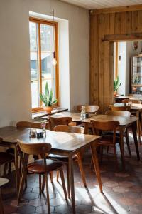 a dining room with wooden tables and chairs at Arctic River Lodge in Tärendö +32 photos