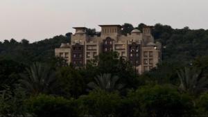 a large building on top of a hill with trees at Private & Serene Golf View Apt Phase 7 in Rawalpindi