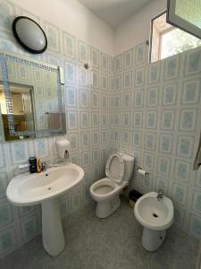 a bathroom with a sink and a toilet and a mirror at Top view hostel in Durrës +77 photos