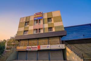 a building with a sign on the side of it at FabHotel Wagholi Inn in Pune