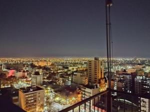 a view of a city at night at Apartamento Star in Mendoza +3 photos