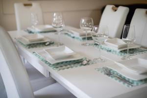 a table with wine glasses and plates on it at Henning in Keitum