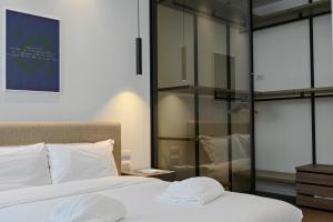 a bedroom with two beds and a glass wall at Palazzo Machiavelli Trieste in Trieste