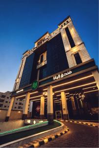 a tall black building with a sign on it at Eliana Hotel in Al Khobar