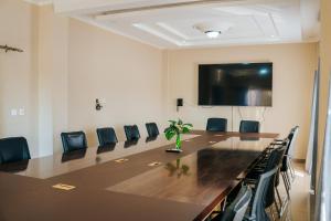 a conference room with a large table and chairs at The Ace Hotel in Lusaka