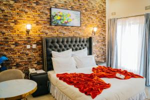 a bedroom with a bed with a red blanket on it at The Ace Hotel in Lusaka +162 photos