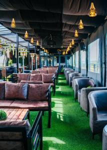 a row of chairs and tables in a restaurant at The Ace Hotel in Lusaka