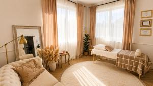 a living room with a bed and a mirror at LOG apartament in Dobrzewino